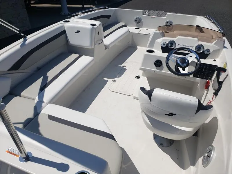 Slide: The Image of 2023 Starcraft SVX 171 OB boat interior with steering wheel and seating. - 21