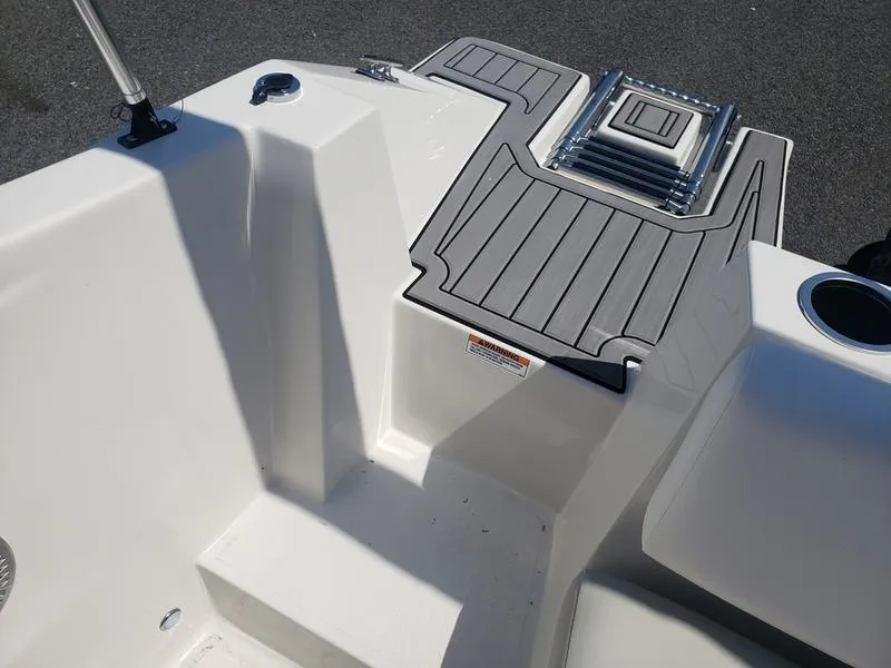 Slide: The Image of 2023 Starcraft SVX 171 OB boat interior with gray non-slip deck and cup holder. - 22
