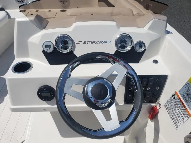Slide: The Image of 2023 Starcraft SVX 171 OB boat dashboard with steering wheel and gauges. - 9
