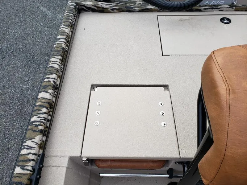 Slide: The Image of 2024 Avid Rogue 20 CC boat interior with camo trim and tan seating. - 12