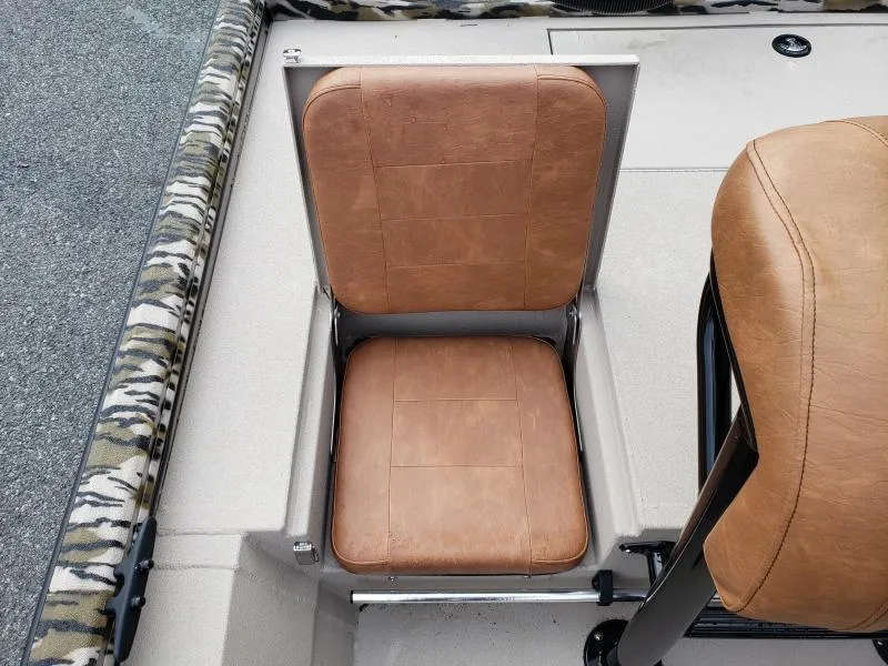 Slide: The Image of 2024 Avid Rogue 20 CC boat seat with brown leather upholstery and camouflage trim. - 13
