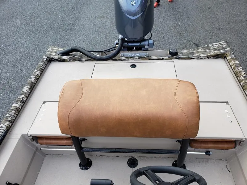 Slide: The Image of 2024 Avid Rogue 20 CC boat interior with tan seating and steering wheel. - 16