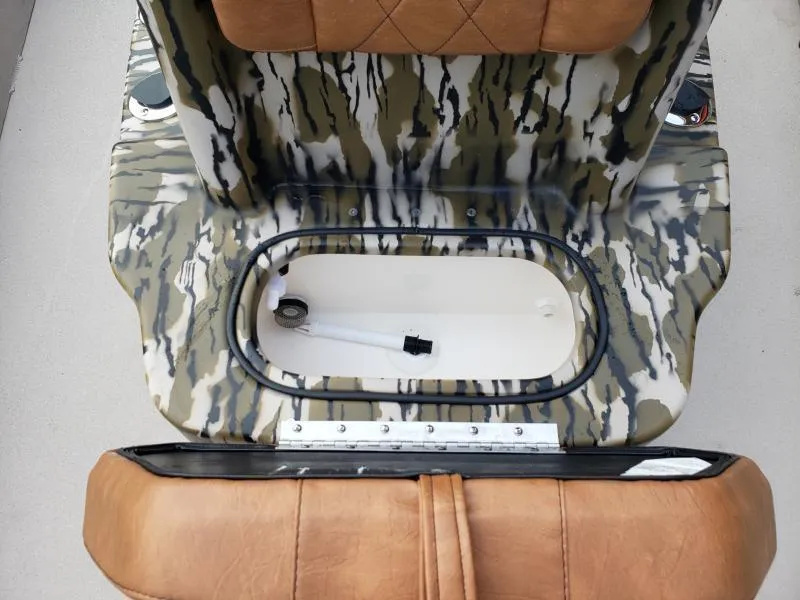 Slide: The Image of 2024 Avid Rogue 20 CC boat seat with camo pattern and storage compartment. - 17