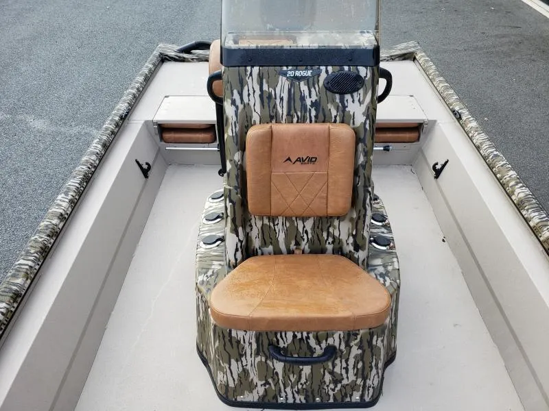 Slide: The Image of 2024 Avid Rogue 20 CC boat interior with camo design and tan seating. - 18