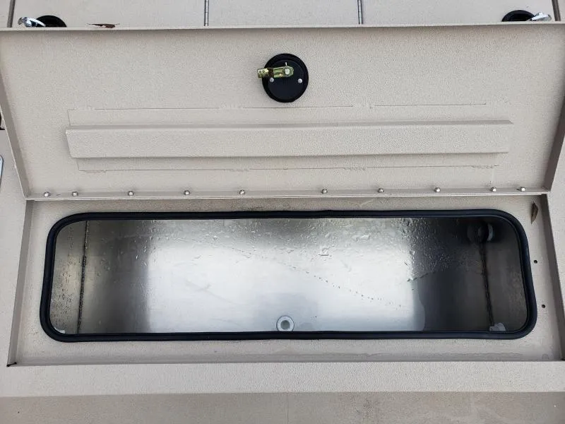 Slide: The Image of Open storage compartment in 2024 Avid Rogue 20 CC boat. - 19