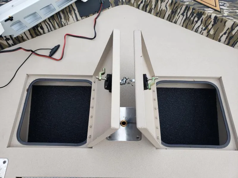 Slide: The Image of 2024 Avid Rogue 20 CC boat storage compartments with open lids and wiring visible. - 20