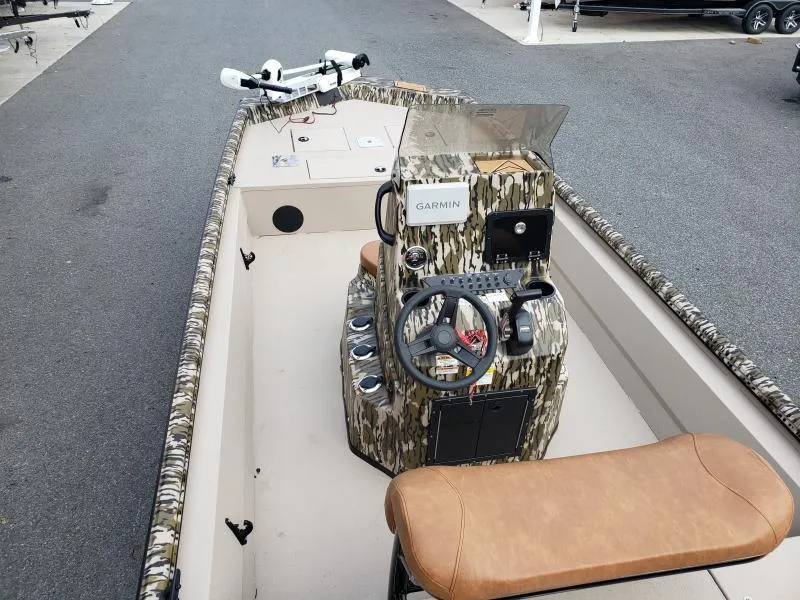 Slide: The Image of 2024 Avid Rogue 20 CC boat interior with camo console and Garmin equipment. - 23
