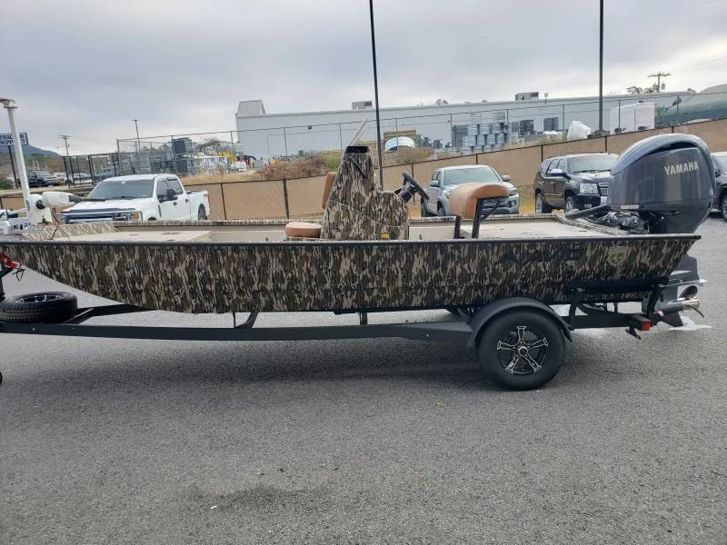 Slide: The Image of 2024 Avid Rogue 20 CC boat with camouflage design on a trailer, parked outdoors. - 4