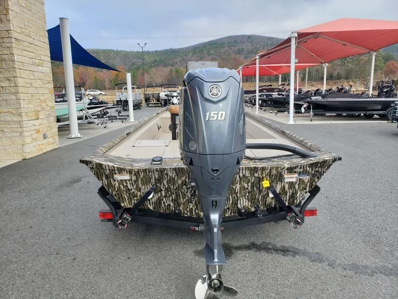 Slide: The Image of 2024 Avid Rogue 20 CC boat with Yamaha 150 outboard motor, parked outdoors. - 8