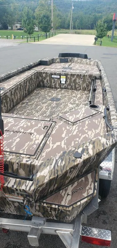 Slide: The Image of 2025 Avid 16 Commander boat with camouflage design on a trailer. - 4