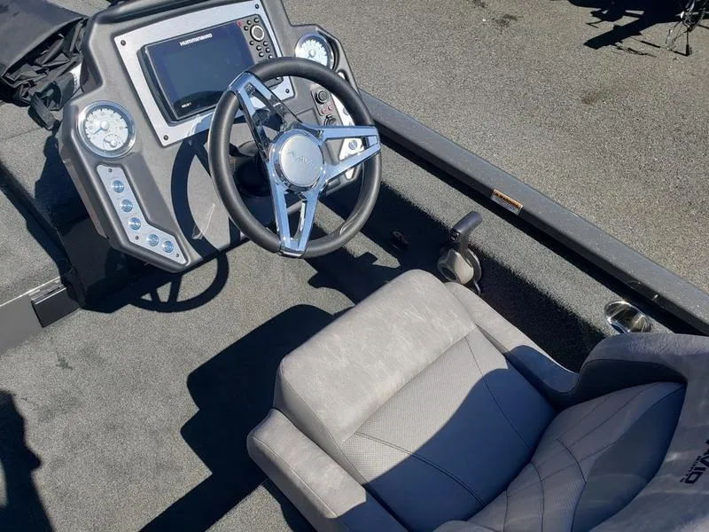 Slide: The Image of 2023 Avid 18XC boat interior with steering wheel and dashboard controls. - 11