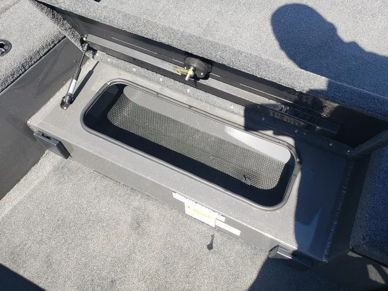 Slide: The Image of 2023 Avid 18XC boat storage compartment with open lid, showing interior details. - 15
