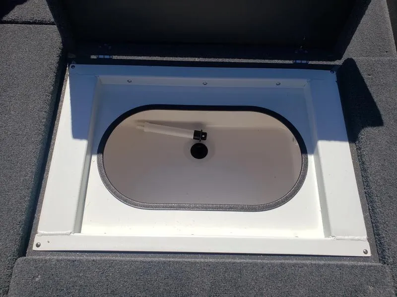 Slide: The Image of 2023 Avid 18XC boat storage compartment with open lid, showcasing interior details. - 17