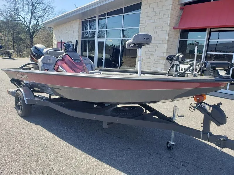 Slide: The Image of 2023 Avid 18XC boat on trailer, parked outside a building. - 19