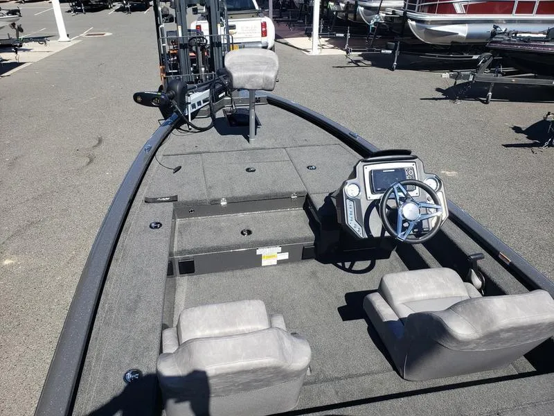 Slide: The Image of 2023 Avid 18XC boat interior with steering wheel and seating. - 23