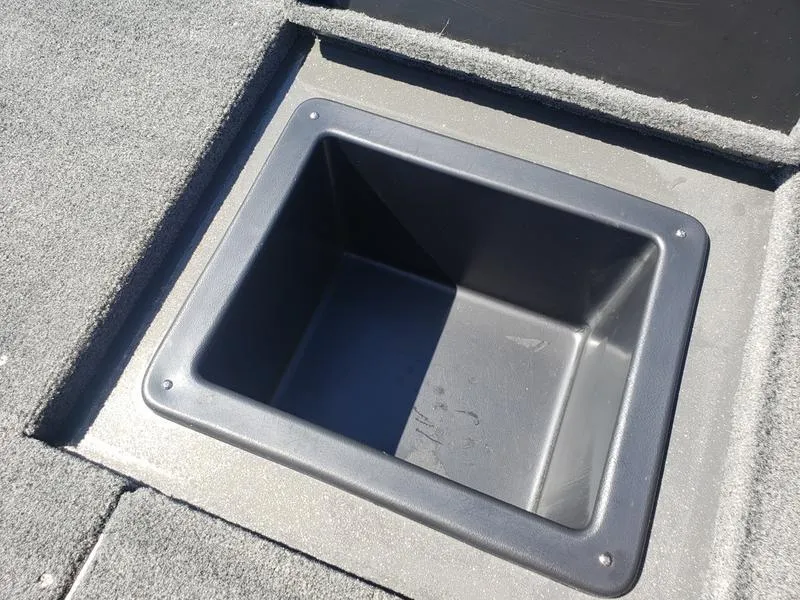 Slide: The Image of Avid 18XC 2023 boat storage compartment with carpeted flooring. - 24