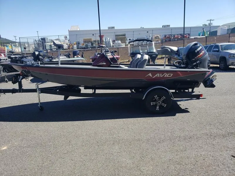Slide: The Image of 2023 Avid 18XC boat on trailer, parked outdoors in a lot. - 3