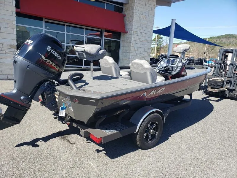Slide: The Image of 2023 Avid 18XC boat with Yamaha motor, parked outdoors on a sunny day. - 5