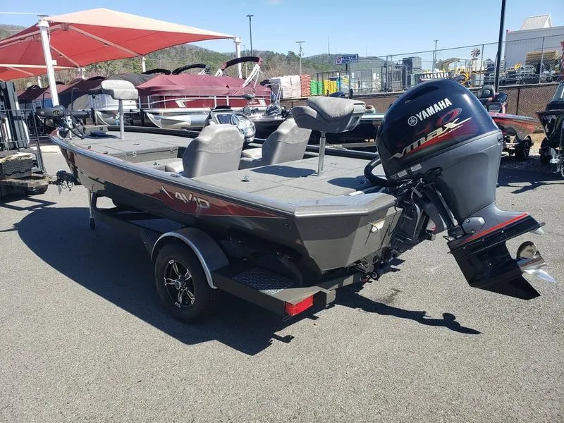 Slide: The Image of 2023 Avid 18XC boat with Yamaha motor, parked outdoors under red canopy. - 6