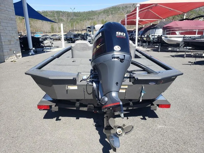 Slide: The Image of Avid 18XC 2023 boat with Yamaha 90 outboard motor, parked outdoors. - 7