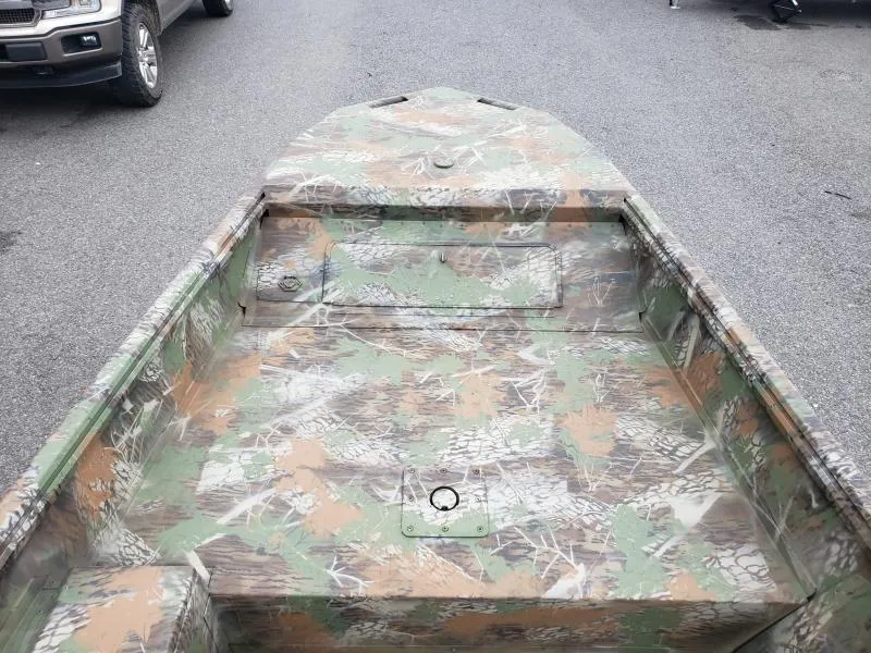 Slide: The Image of 2024 G3 Sportsman 1610 boat with camouflage pattern on a paved surface. - 10