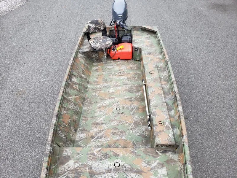 Slide: The Image of 2024 G3 Sportsman 1610 boat with camouflage design and outboard motor. - 12