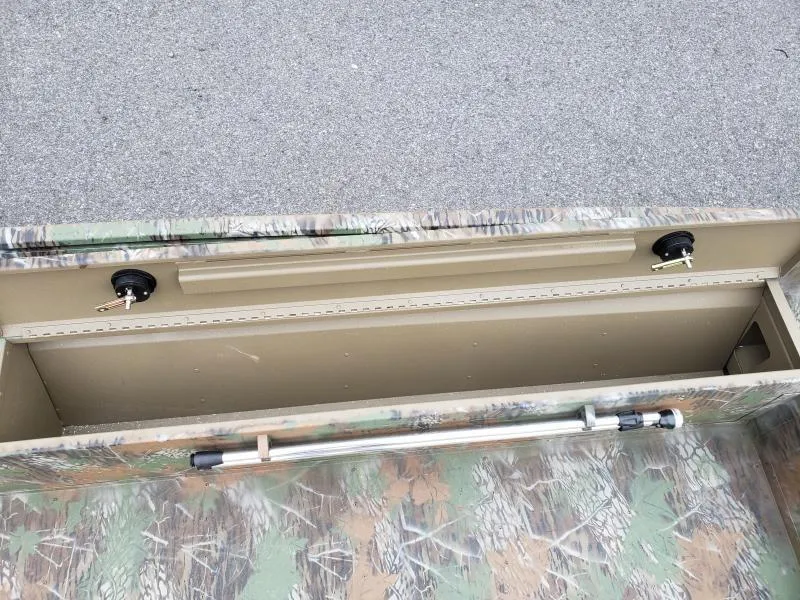 Slide: The Image of 2024 G3 Sportsman 1610 boat storage compartment with camouflage design. - 14