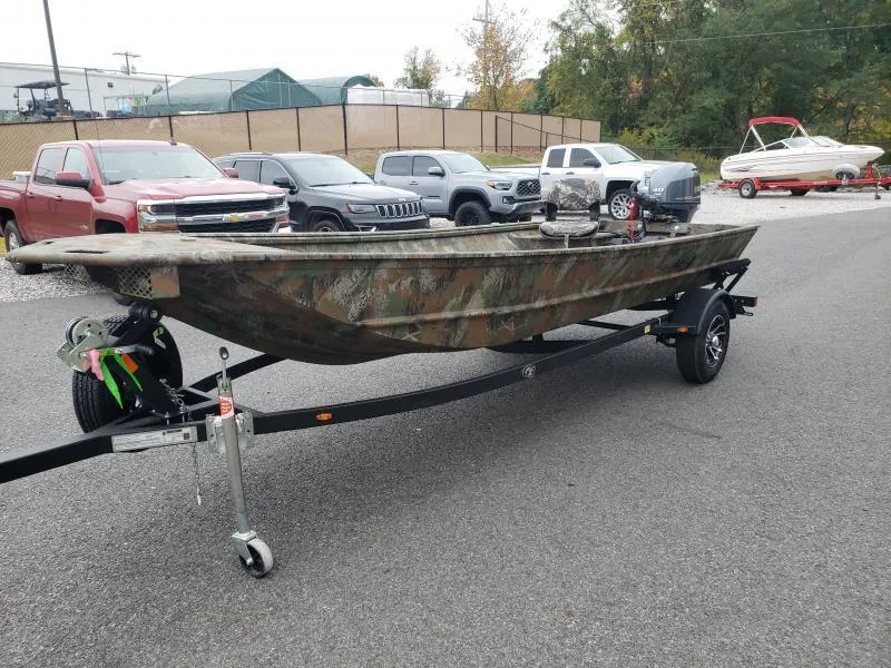 Slide: The Image of 2024 G3 Sportsman 1610 boat on trailer, camo design, parked in lot with cars. - 4