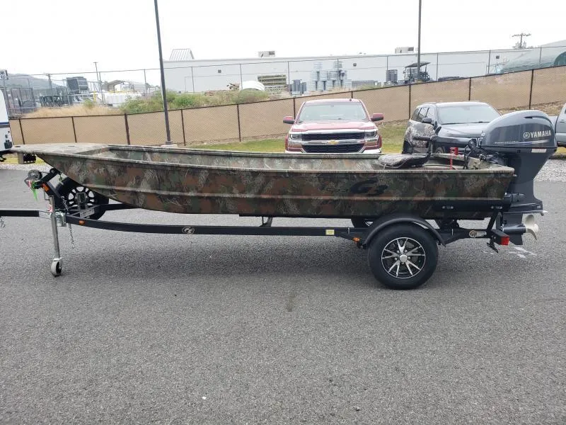 Slide: The Image of 2024 G3 Sportsman 1610 boat on trailer with Yamaha motor, parked outdoors. - 5