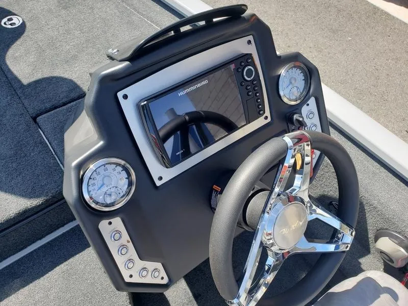 Slide: The Image of 2023 Avid 18XB boat dashboard with steering wheel and Humminbird display. - 13