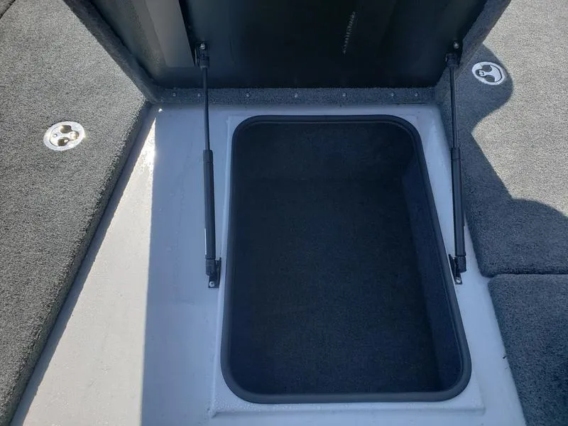 Slide: The Image of 2023 Avid 18XB boat storage compartment with hydraulic lift supports. - 17