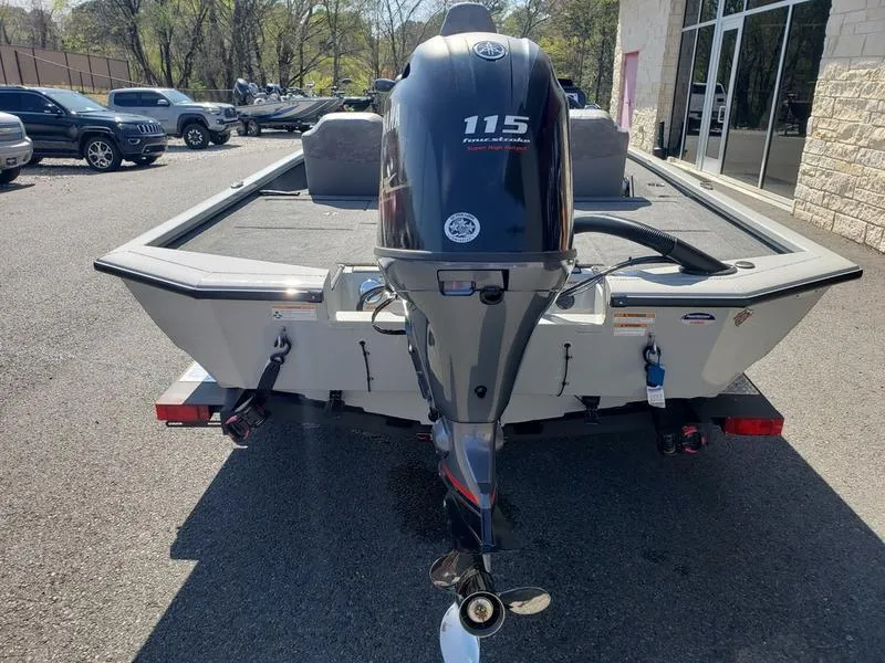 Slide: The Image of 2023 Avid 18XB boat with Yamaha 115 outboard motor, parked outdoors. - 6