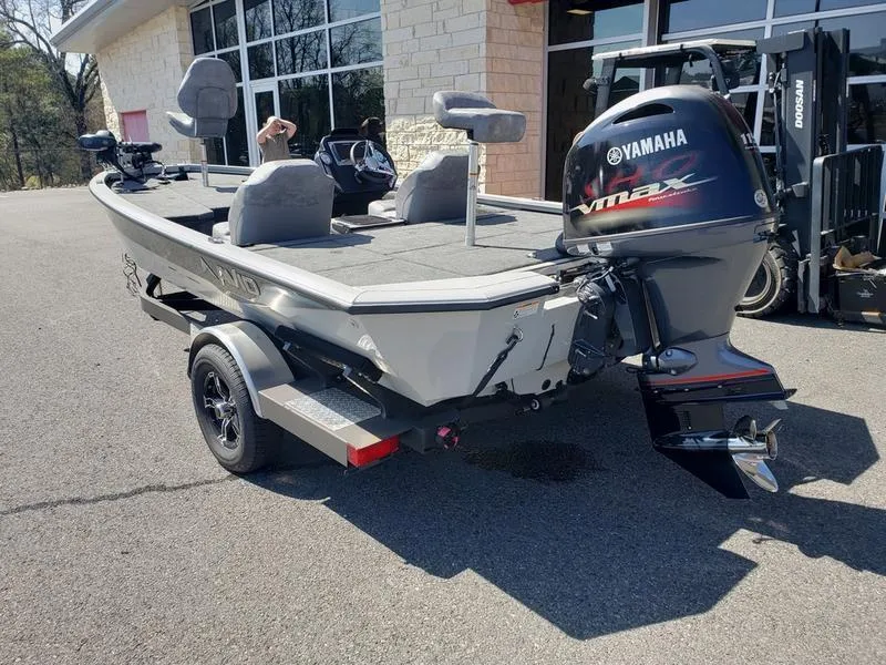 Slide: The Image of 2023 Avid 18XB boat with Yamaha VMAX engine, parked outside a building. - 7