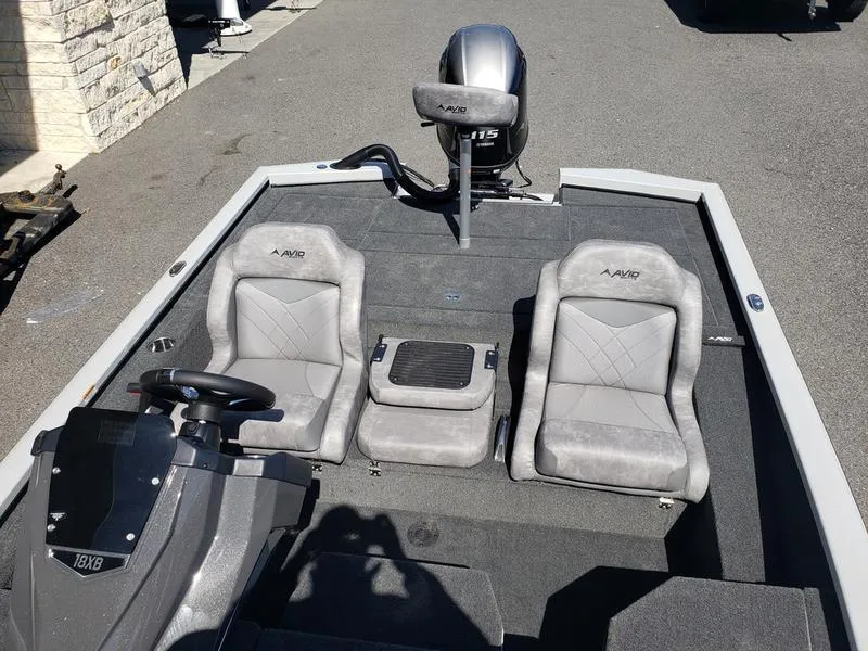 Slide: The Image of 2023 Avid 18XB boat interior with two gray seats and steering console. - 8