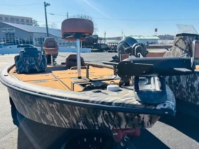 Slide: The Image of 2024 Avid 19XB boat with camouflage design, featuring seating and equipment on deck. - 1