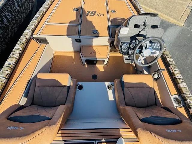 Slide: The Image of 2024 Avid 19XB boat interior with dual seats and steering console. - 12