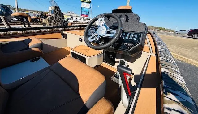 Slide: The Image of 2024 Avid 19XB boat interior with steering wheel and control panel. - 15