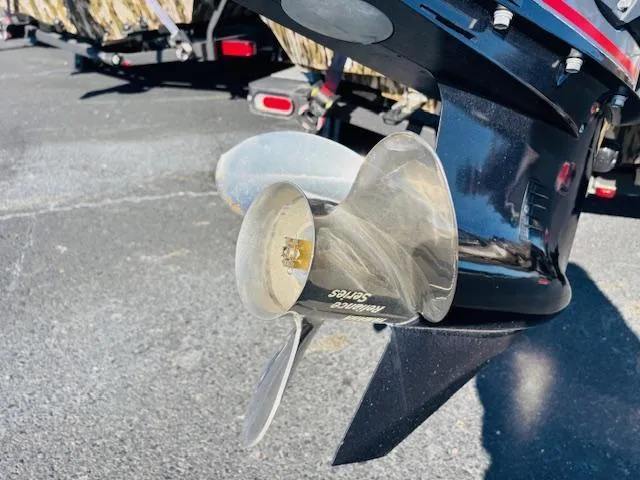 Slide: The Image of 2024 Avid 19XB boat propeller, close-up view in a parking lot. - 16