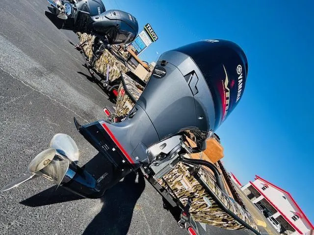 Slide: The Image of 2024 Avid 19XB boat with Yamaha outboard motor in a parking lot. - 17