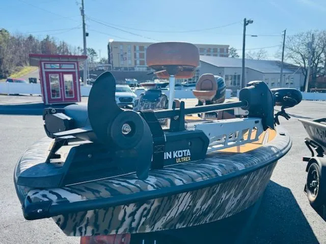 Slide: The Image of 2024 Avid 19XB boat with Minn Kota Ultrex motor in a parking lot. - 4