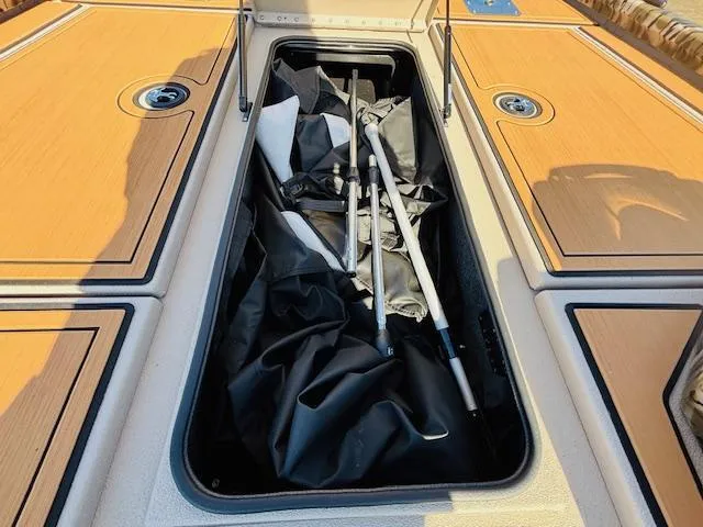 Slide: The Image of Storage compartment on a 2024 Avid 19XB boat with equipment and gear. - 9