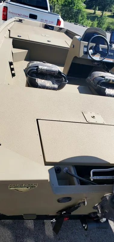 Slide: The Image of 2024 G3 17 SC boat interior with steering wheel and seating, parked near a white truck. - 4