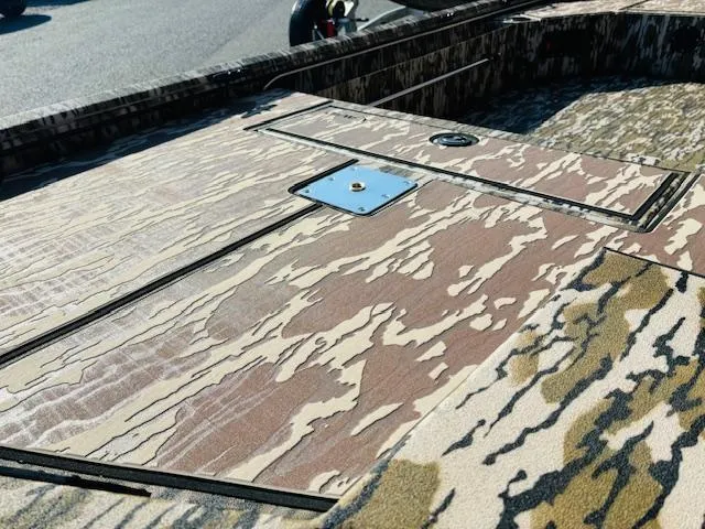 Slide: The Image of Camouflage deck of 2025 Avid 16COM boat under sunlight. - 5