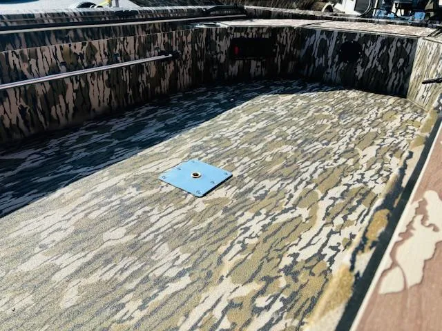 Slide: The Image of Avid 16COM 2025 boat interior with camouflage pattern flooring. - 6