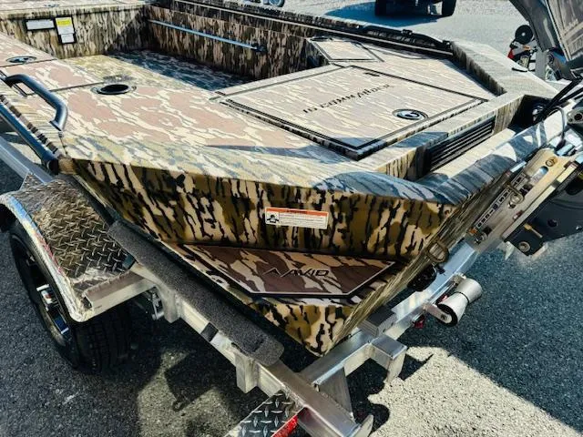 Slide: The Image of Avid 16COM 2025 camouflage boat on trailer, featuring rugged design and durable construction. - 8