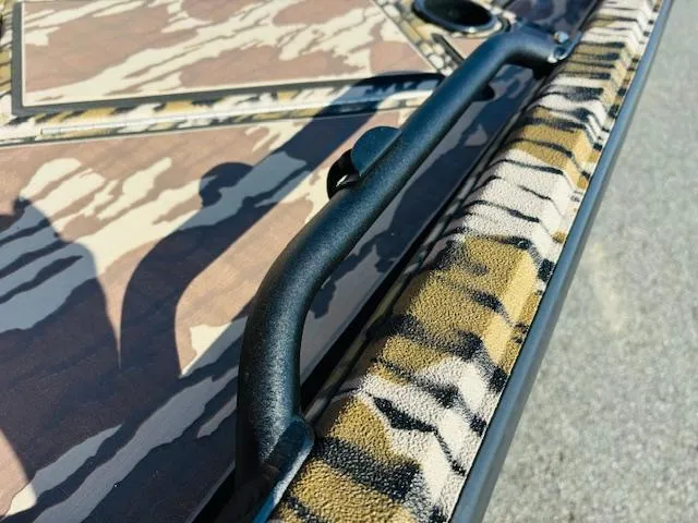 Slide: The Image of Avid 16COM 2025 boat with camouflage pattern and sturdy black handle. - 9