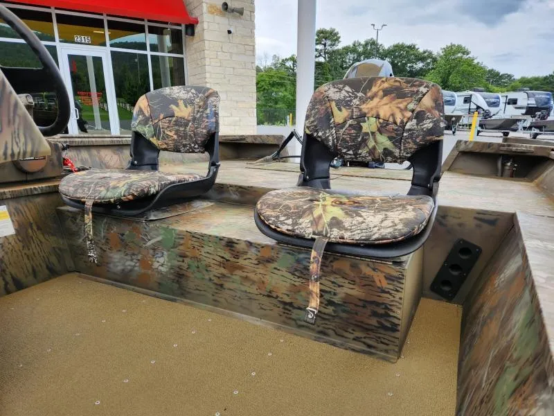 Slide: The Image of 2024 G3 17 SC boat with camo seats, outdoor setting. - 12