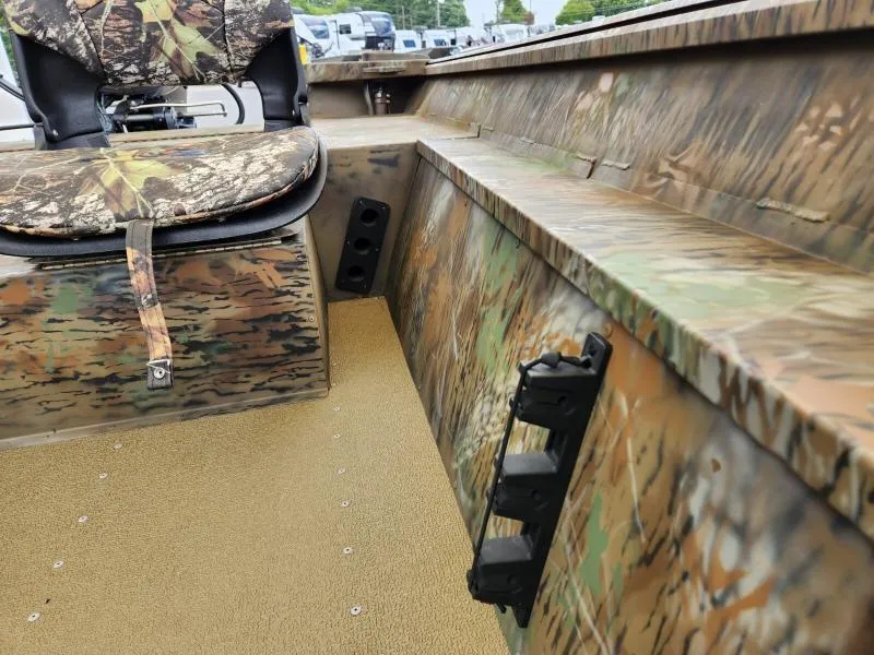 Slide: The Image of 2024 G3 17 SC boat interior with camouflage seating and flooring. - 13
