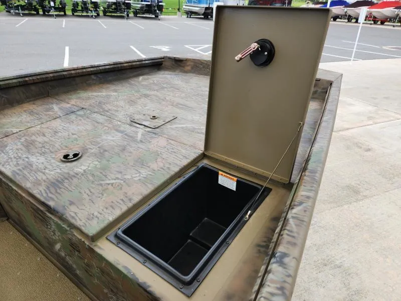 Slide: The Image of 2024 G3 17 SC boat with open storage compartment in a parking lot. - 17