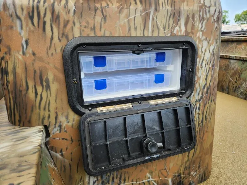 Slide: The Image of Camouflage storage compartment on 2024 G3 17 SC boat with tackle boxes inside. - 18